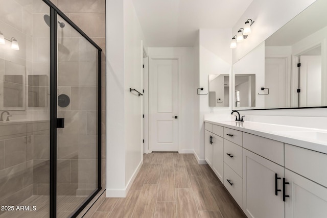 40563 W Michaels Dr, Maricopa, AZ 85138 - bathroom with double vanity, a shower stall, and baseboards