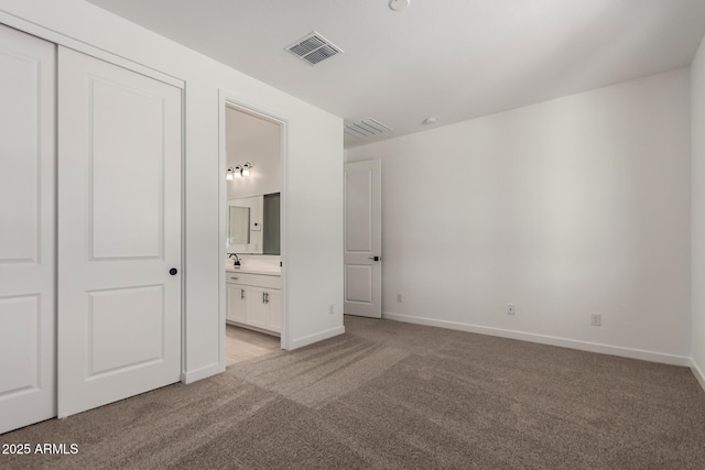 40563 W Michaels Dr, Maricopa, AZ 85138 - unfurnished bedroom featuring light carpet, baseboards, ensuite bath, and a closet