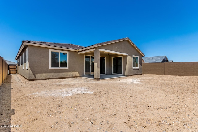 40563 W Michaels Dr, Maricopa, AZ 85138 - rear view of property featuring stucco siding, a fenced backyard, and a patio area