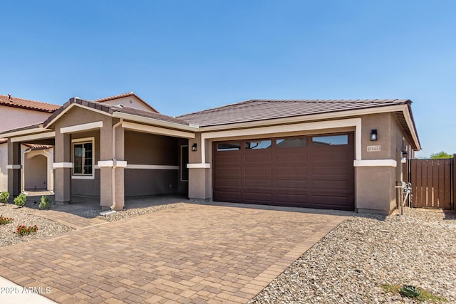 40563 W Michaels Dr, Maricopa, AZ 85138 - view of front of house with a garage, decorative driveway, a tiled roof, and stucco siding