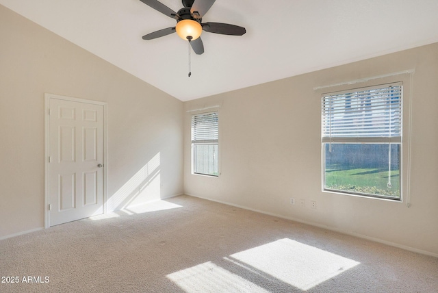 carpeted spare room featuring lofted ceiling, plenty of natural light, and ceiling fan