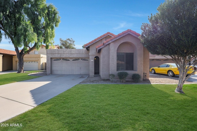 mediterranean / spanish house with a garage and a front yard