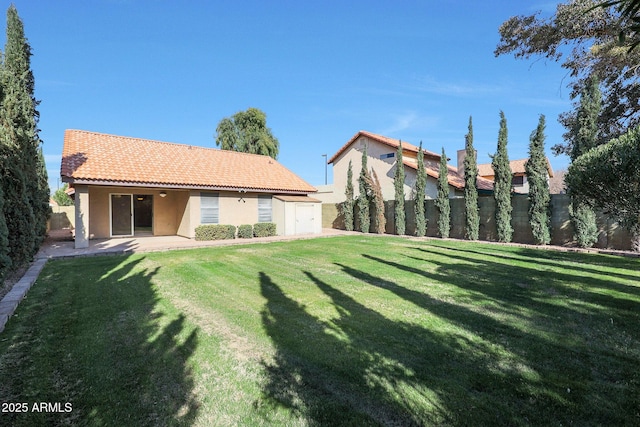 rear view of house featuring a storage shed, a yard, and a patio area