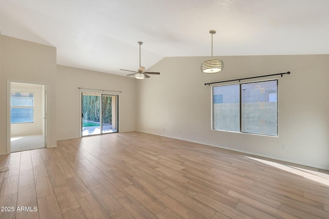 unfurnished room featuring ceiling fan, lofted ceiling, and light hardwood / wood-style floors