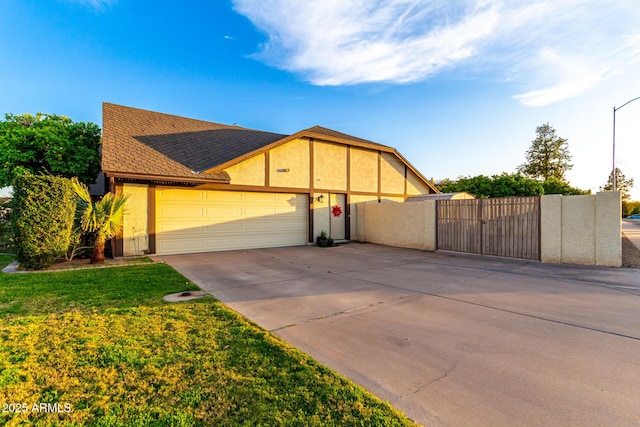 view of front of house featuring a gate, an attached garage, driveway, stucco siding, and roof with shingles