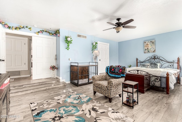 bedroom featuring wood finished floors, baseboards, and ceiling fan