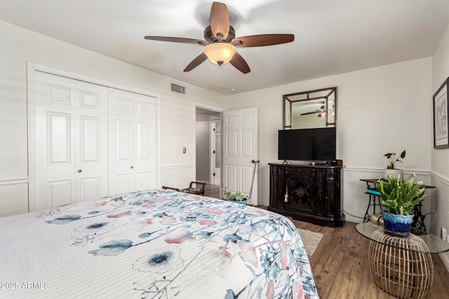 bedroom with wood finished floors, a closet, and a ceiling fan