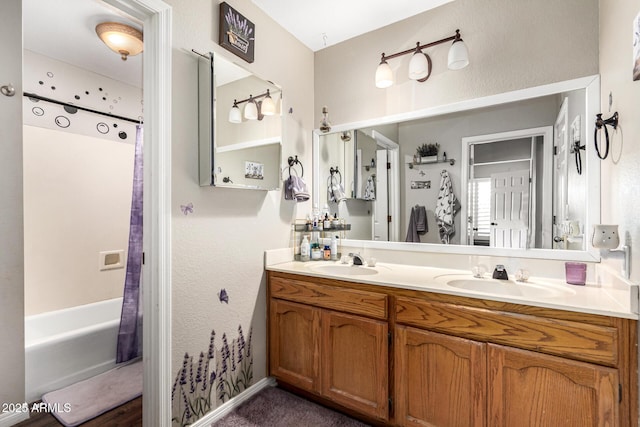 bathroom featuring double vanity and shower / bathtub combination with curtain
