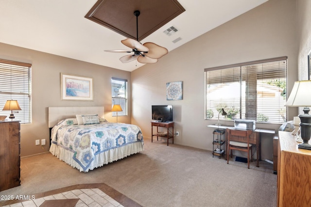 bedroom with multiple windows, ceiling fan, and light carpet