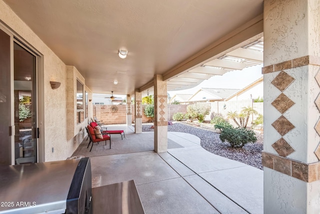 view of patio featuring ceiling fan