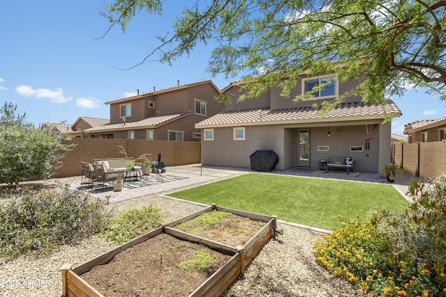 6338 W Raymond St, Phoenix, AZ 85043 - rear view of property with a vegetable garden, stucco siding, a patio, and a tiled roof