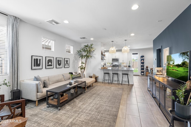 6338 W Raymond St, Phoenix, AZ 85043 - living room with recessed lighting and light tile patterned flooring