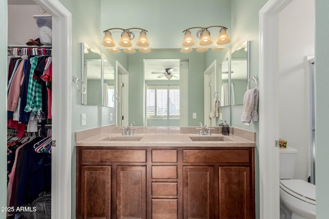 bathroom featuring ceiling fan, toilet, and vanity