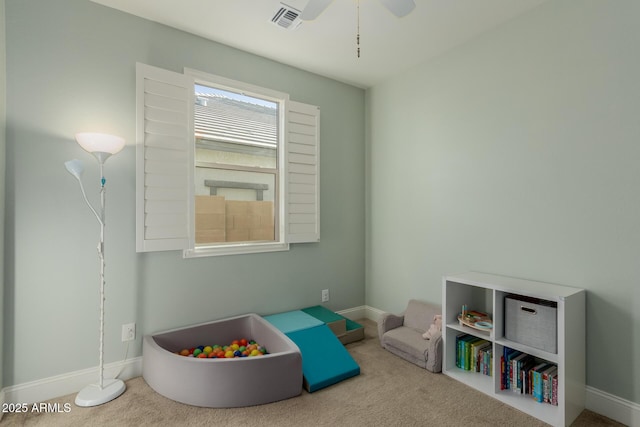 recreation room featuring light colored carpet