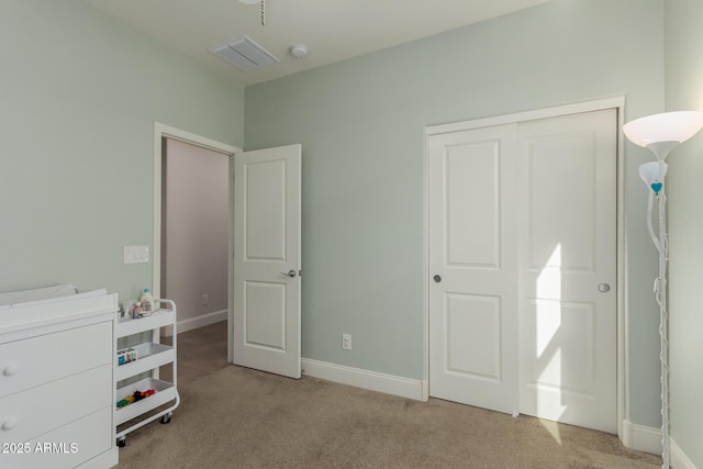 bedroom featuring light colored carpet and a closet