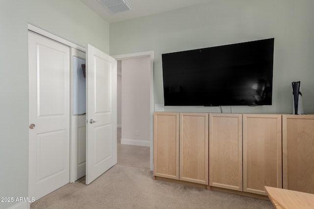 interior space featuring light colored carpet