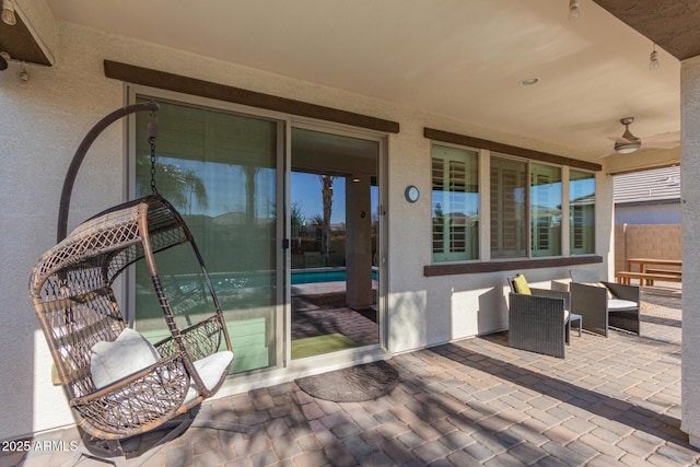 view of patio with ceiling fan and an outdoor living space