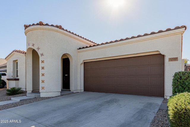 mediterranean / spanish house with a garage