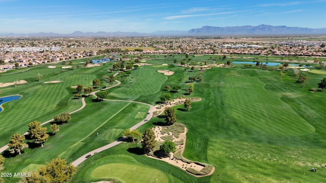 birds eye view of property with view of golf course and a water and mountain view