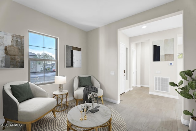 sitting room with visible vents and baseboards