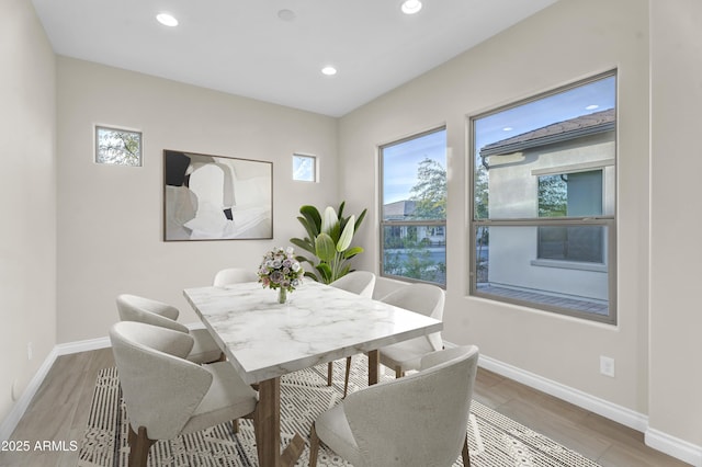 dining space featuring recessed lighting, baseboards, and wood finished floors