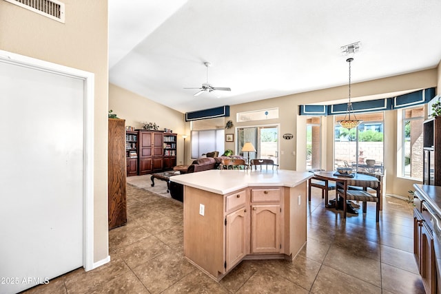 15194 W Vale Dr, Goodyear, AZ 85395 - kitchen with a ceiling fan, light countertops, open floor plan, hanging light fixtures, and a kitchen island