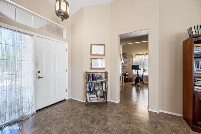 15194 W Vale Dr, Goodyear, AZ 85395 - foyer with a towering ceiling and dark tile patterned floors