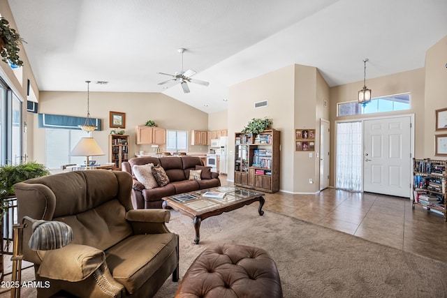 15194 W Vale Dr, Goodyear, AZ 85395 - carpeted living room featuring high vaulted ceiling, a ceiling fan, plenty of natural light, and tile patterned flooring
