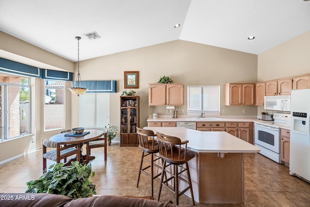 15194 W Vale Dr, Goodyear, AZ 85395 - kitchen featuring white appliances, light brown cabinets, light countertops, high vaulted ceiling, and hanging light fixtures