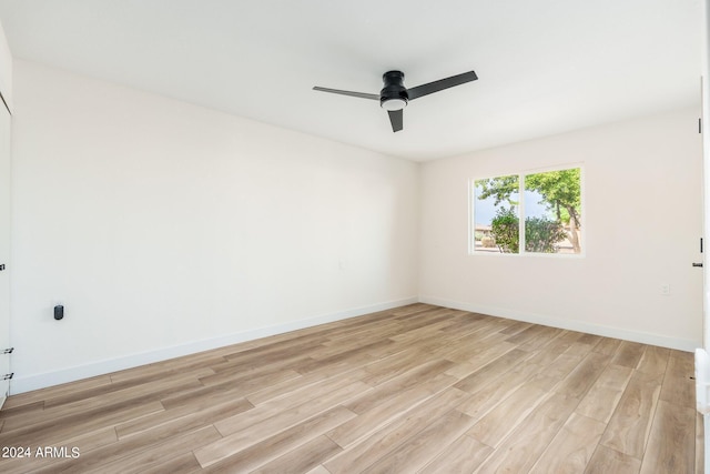 unfurnished room featuring ceiling fan and light wood-type flooring