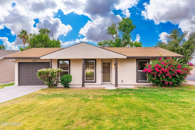 single story home featuring a garage and a front lawn