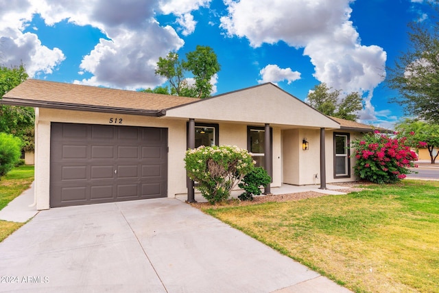 single story home featuring a garage and a front lawn