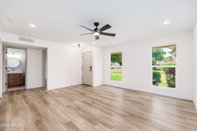 spare room featuring ceiling fan and light hardwood / wood-style floors