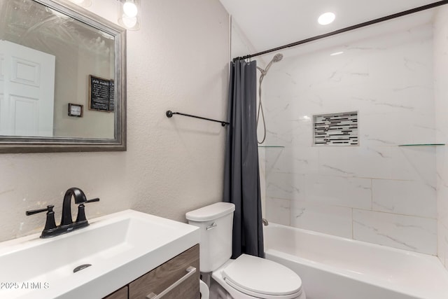 bathroom featuring vanity, toilet, a textured wall, and shower / bath combo with shower curtain