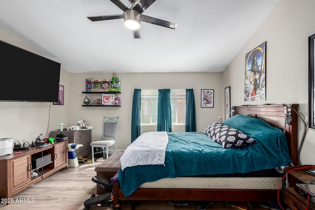 bedroom with a ceiling fan and light wood-type flooring