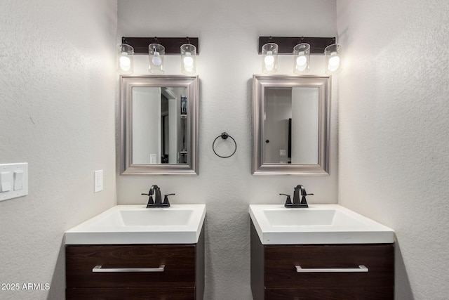 bathroom featuring two vanities and a sink