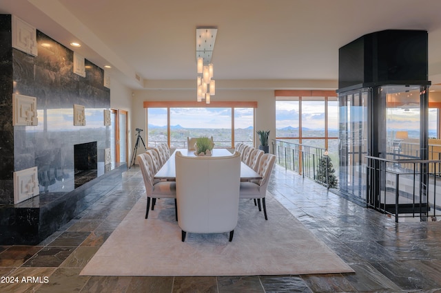 dining room featuring a mountain view and a high end fireplace