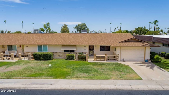 ranch-style home with a garage, driveway, brick siding, and a front lawn