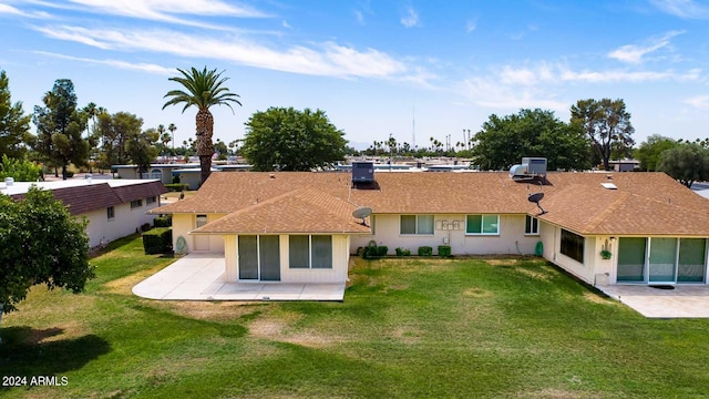 rear view of property with a yard and a patio