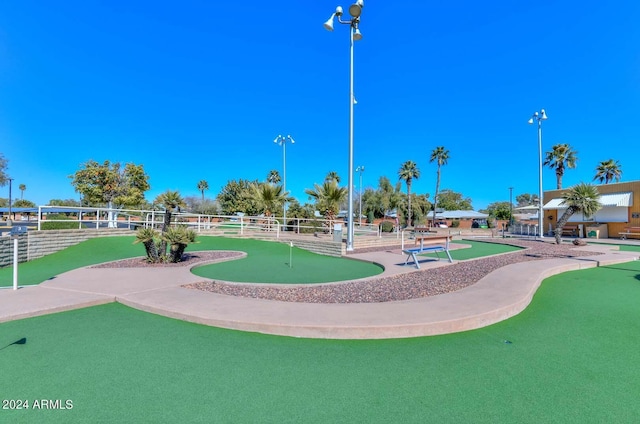 view of patio / terrace with a water view and tennis court