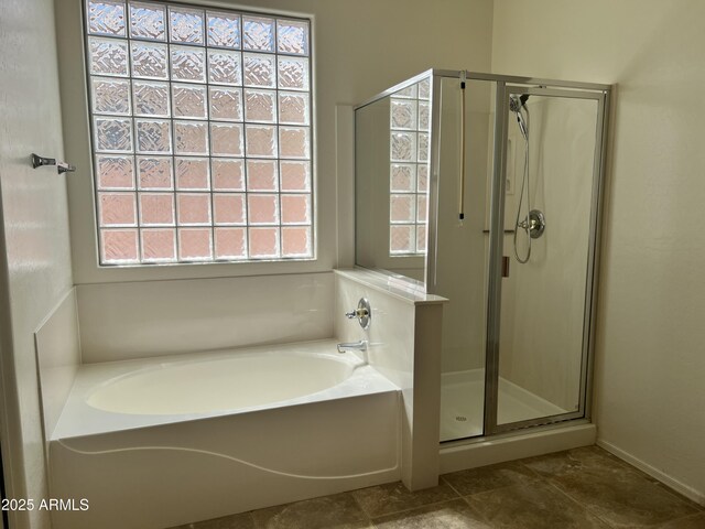 bathroom with a shower stall, a garden tub, tile patterned flooring, and a wealth of natural light