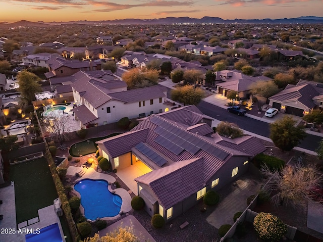 aerial view at dusk featuring a mountain view