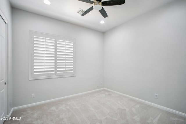 carpeted spare room with ceiling fan