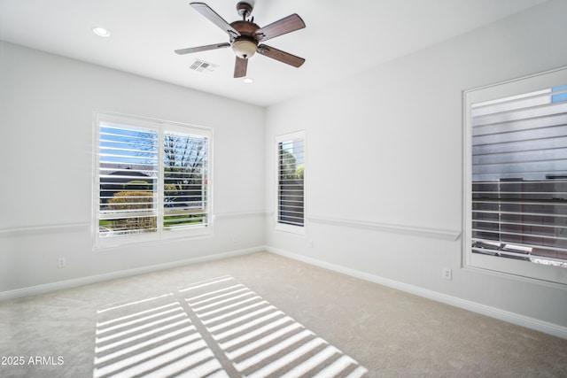 carpeted empty room featuring ceiling fan