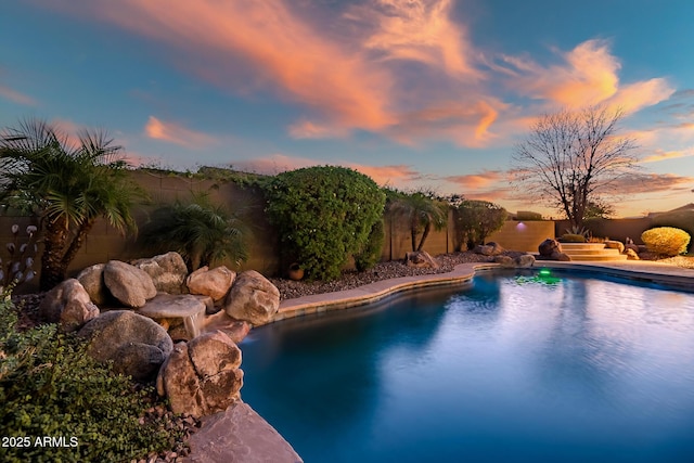 view of pool at dusk