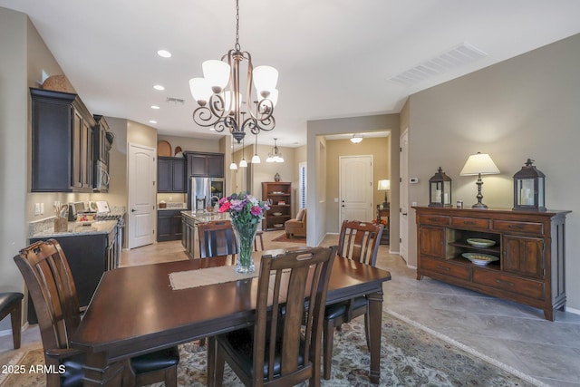 dining area featuring sink and an inviting chandelier