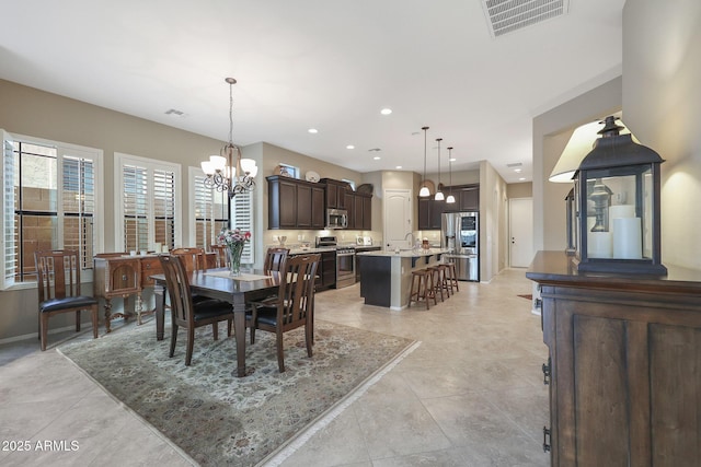 dining area with sink and a chandelier