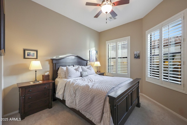 bedroom with ceiling fan and light carpet