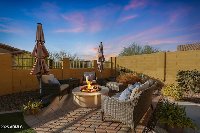 patio terrace at dusk with an outdoor fire pit