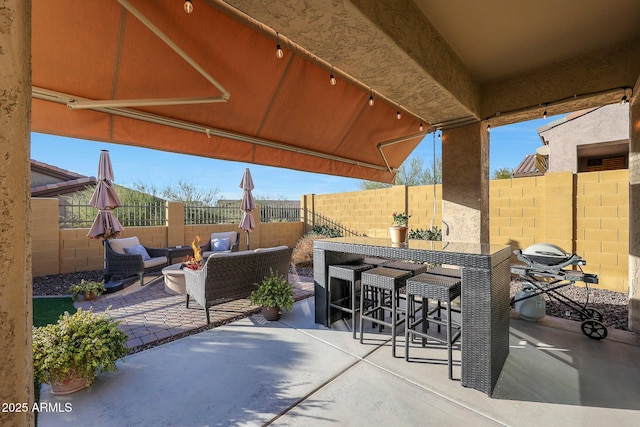 view of patio with a bar and an outdoor hangout area